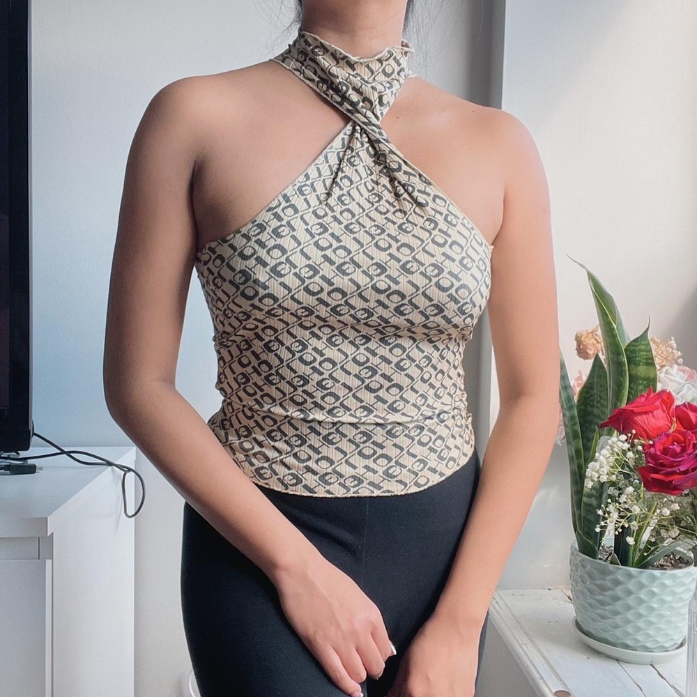 Printed halter top in a fitted silhouette with a mock neckline and racerback.